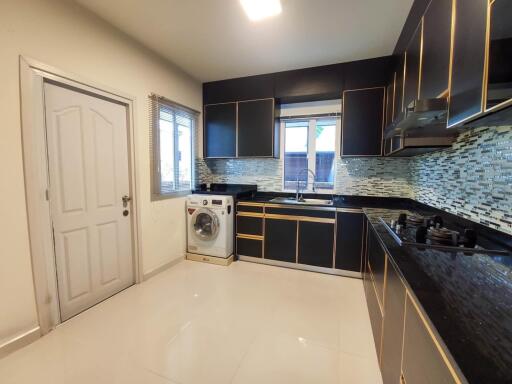 Modern kitchen with stainless steel appliances and mosaic backsplash