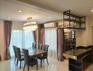 Elegant dining and living area with modern furnishings and lighting