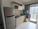 Modern kitchen with stainless steel appliances and city view