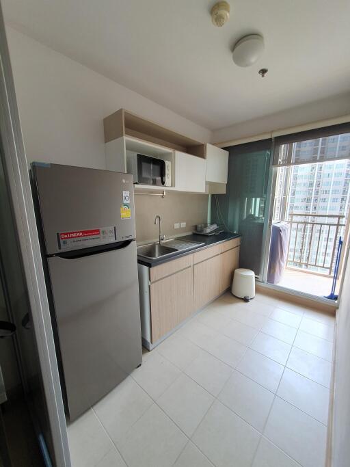 Modern kitchen with stainless steel appliances and city view