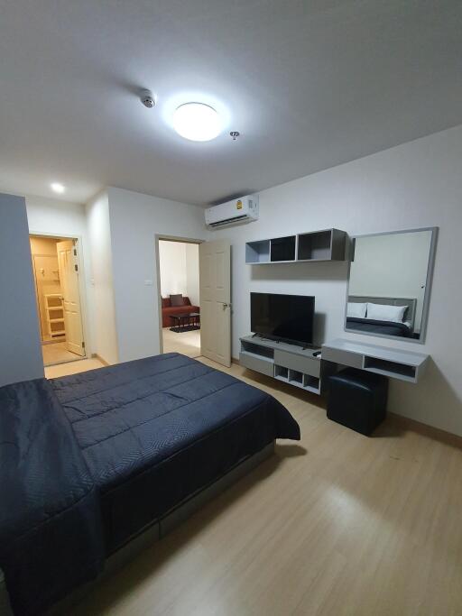 Modern bedroom with en-suite bathroom, air conditioning, and mounted television