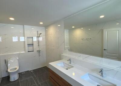 Modern bathroom with double vanity and large mirror