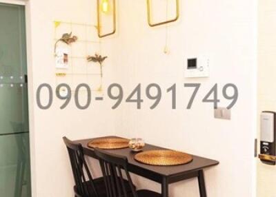 Compact dining area with modern pendant lighting and a simple dining set