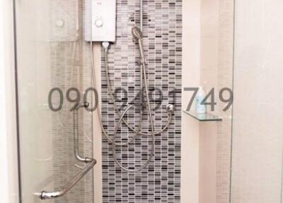 Modern bathroom with walk-in shower and mosaic tile wall