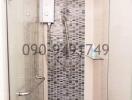 Modern bathroom with walk-in shower and mosaic tile wall
