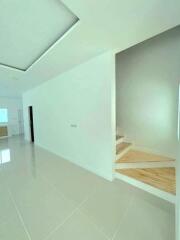 Modern spacious building interior with white walls and glossy tiled flooring