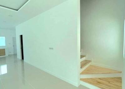 Modern spacious building interior with white walls and glossy tiled flooring