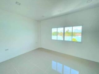 Spacious unfurnished bedroom with large windows and ample natural light
