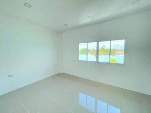 Spacious unfurnished bedroom with large windows and ample natural light