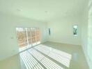 Spacious and bright empty living room with large windows