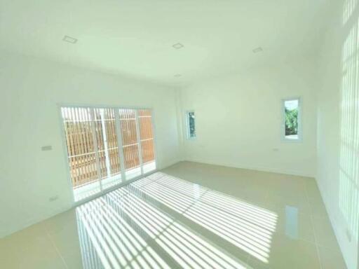Spacious and bright empty living room with large windows