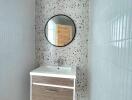 Modern bathroom with terrazzo flooring and wall-mounted sink