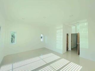 Spacious and well-lit empty living room with large windows