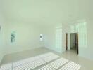 Spacious and well-lit empty living room with large windows