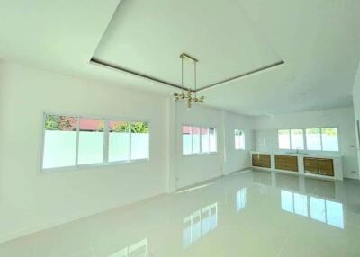 Spacious and well-lit living room with glossy floor tiles