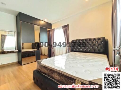 Spacious bedroom with large bed and modern furnishings