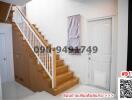 Wooden stairway and white door in a modern home entryway