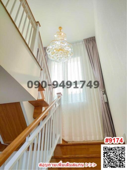 Elegant staircase with chandelier and wooden bannisters