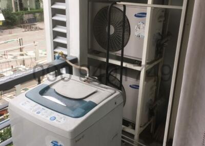 Compact laundry area with washing machine on a residential balcony