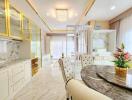 Elegant dining room with marble flooring and detailed gold accents