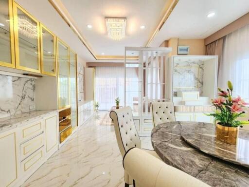 Elegant dining room with marble flooring and detailed gold accents