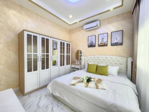 Elegantly furnished bedroom with a comfortable double bed and modern amenities