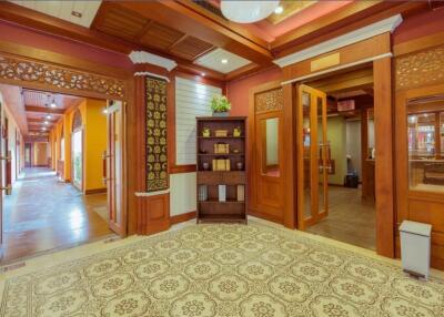 Elegant wooden hallway with decorative carpet and ornate doors