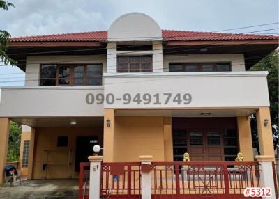 Two-story residential building with an orange facade and tile roof