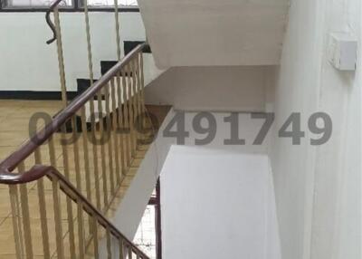 Interior staircase in a residential building, showing stairs and railings