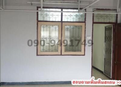 Interior view of an empty room with tiled floor and white walls