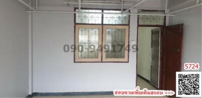 Interior view of an empty room with tiled floor and white walls