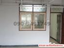 Interior view of an empty room with tiled floor and white walls