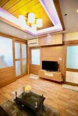 Contemporary living room with wooden paneling and ambient lighting