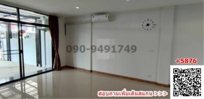 Spacious living room with large windows and air conditioning unit