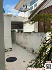 Side exterior view of a residential building with a walkway