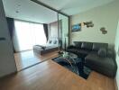 Modern living room with seamless bedroom view, featuring a comfortable seating area and natural light