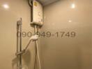 Modern bathroom with wall-mounted water heater and shower