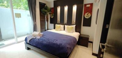 Modern bedroom with a king-sized bed and decorative lighting