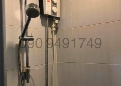 Modern bathroom with water heater and shower fixture