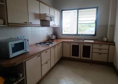 Spacious kitchen with modern appliances and large window