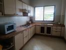 Spacious kitchen with modern appliances and large window