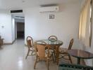 Spacious dining area with glass table and natural light