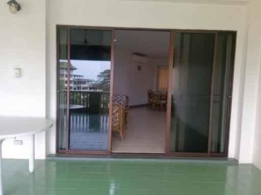 Spacious balcony with tile flooring and a view into the living area