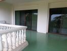 Spacious balcony with green floor tiles and a scenic view