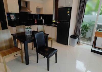 Modern kitchen with dining area and tiled floors