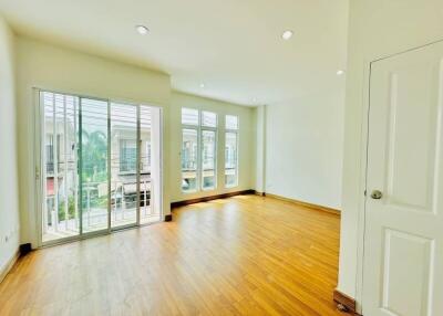 Spacious and bright living room with large windows and hardwood floors