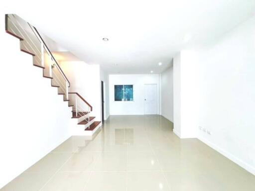 Bright open space with staircase and tiled flooring