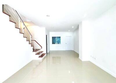 Bright open space with staircase and tiled flooring