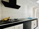 Modern kitchen with white tile backsplash and black cabinets