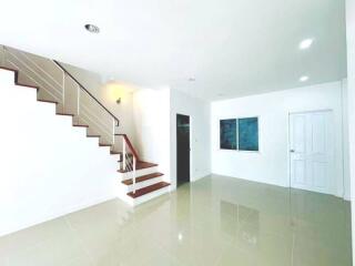 Spacious and bright stairway area with tiled flooring in a modern home